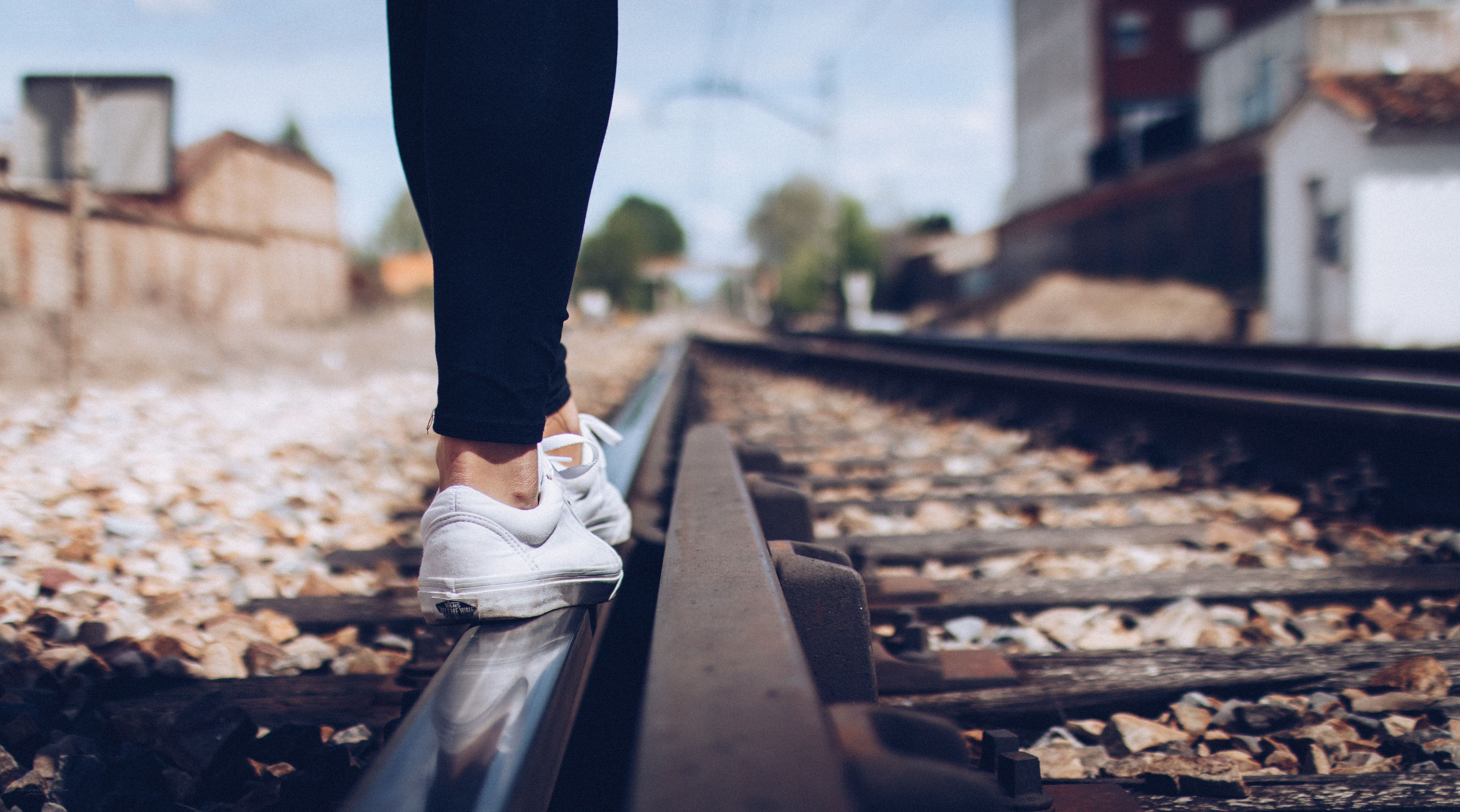 person walking on train tracks