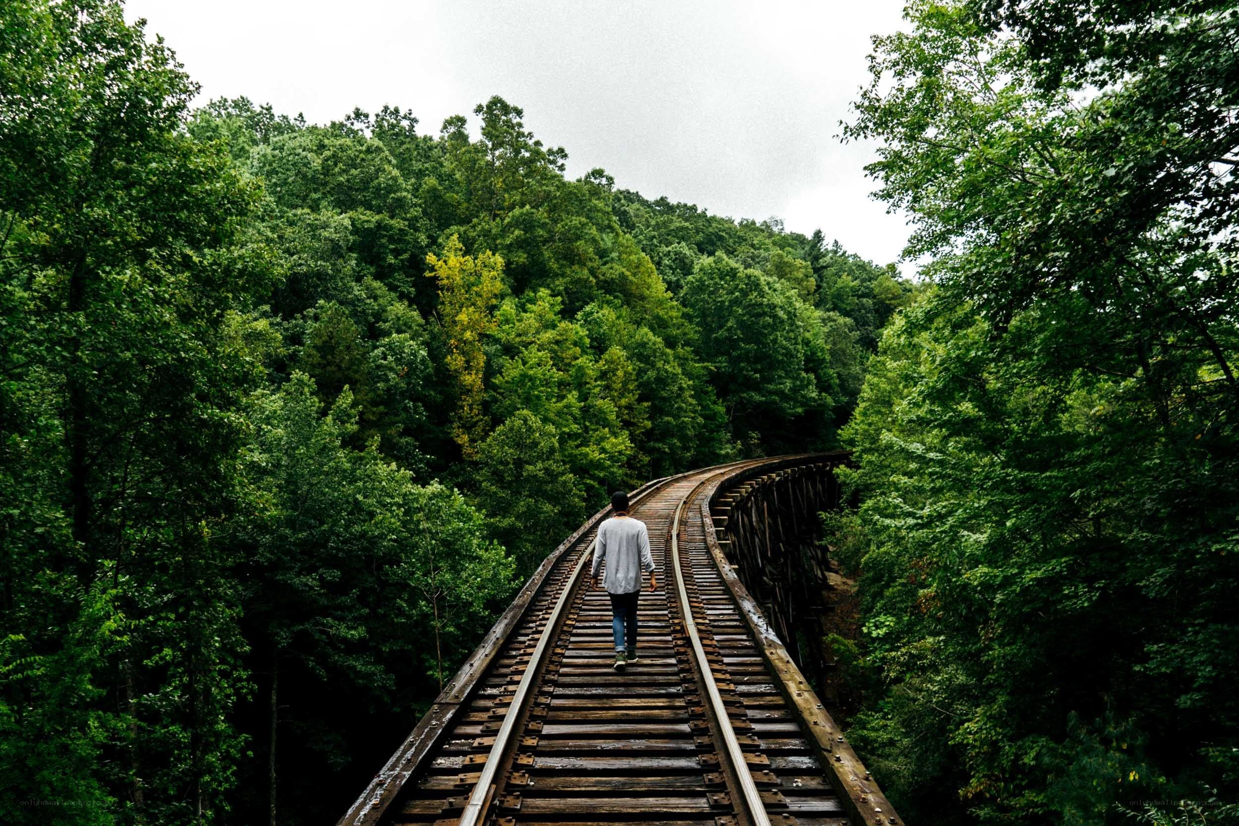 person walking on train tracks