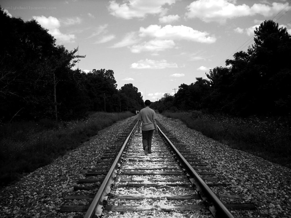 person walking on train tracks