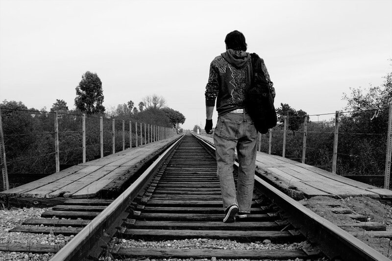 Person Walking on Train Tracks — Black