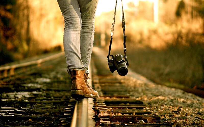 Person Walking on Train Tracks — Brown