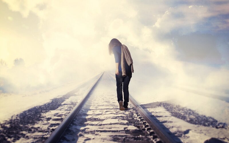 Person Walking on Train Tracks — White, Dramatic