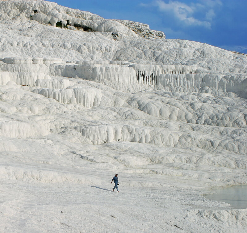 Person walking on travertine terraces