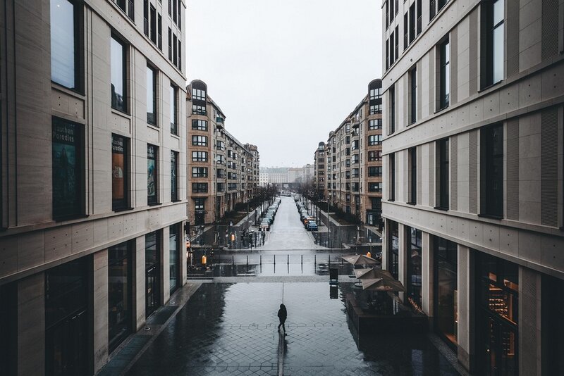 Person Walking on Wet Street