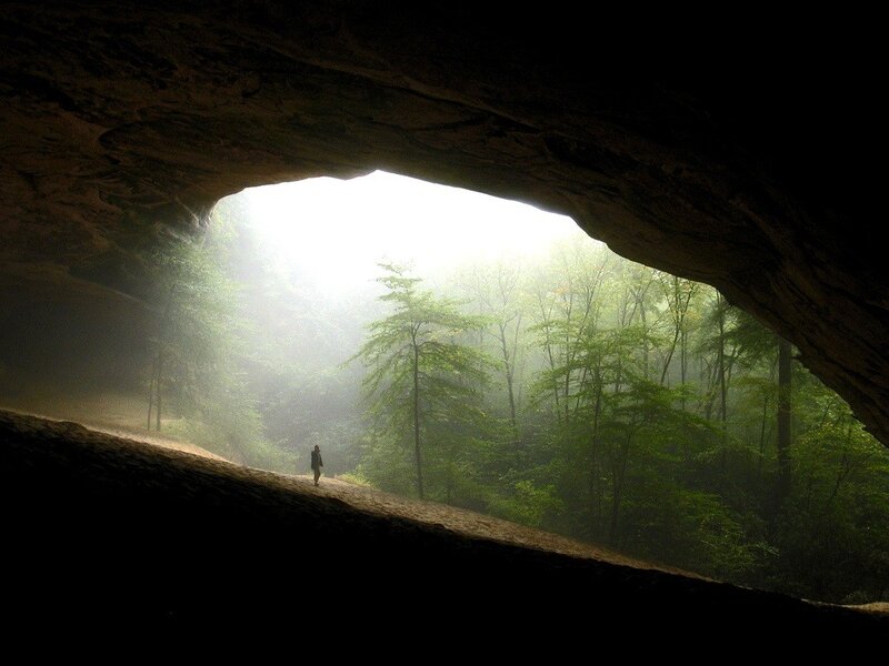 Person walking out of a cave