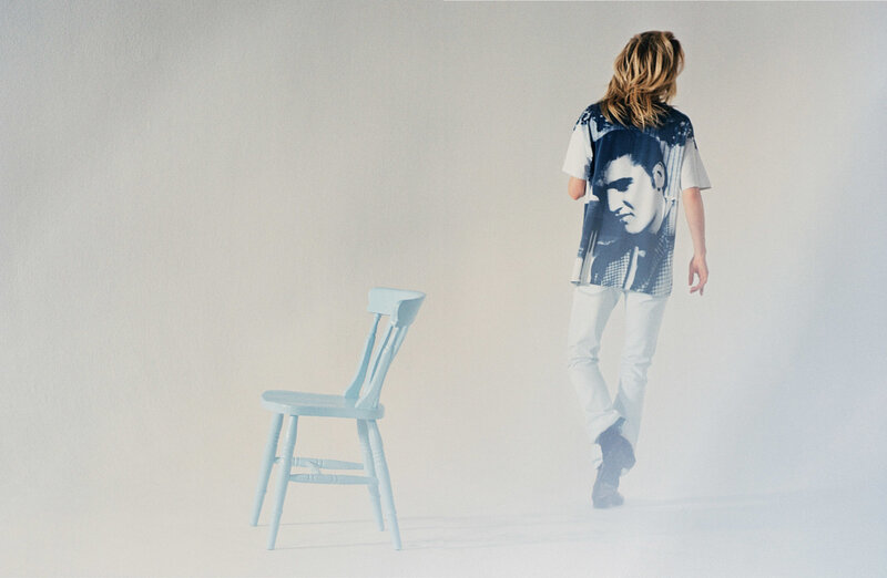 person walking past a chair