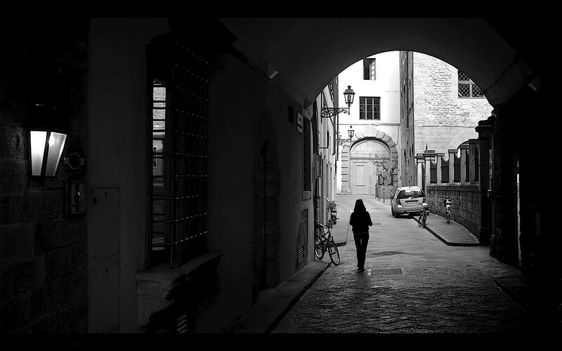 person walking through alleyway