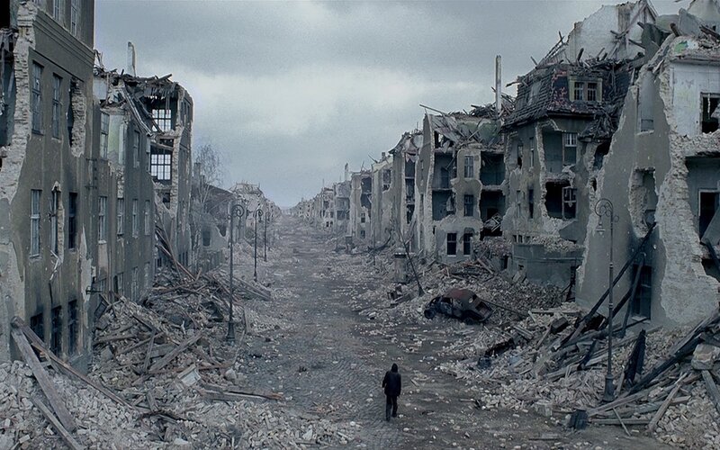 Person Walking Through Ruins — Gray