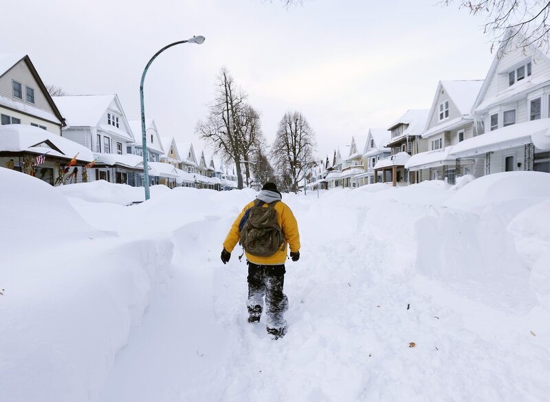 Person walking through snow-covered street