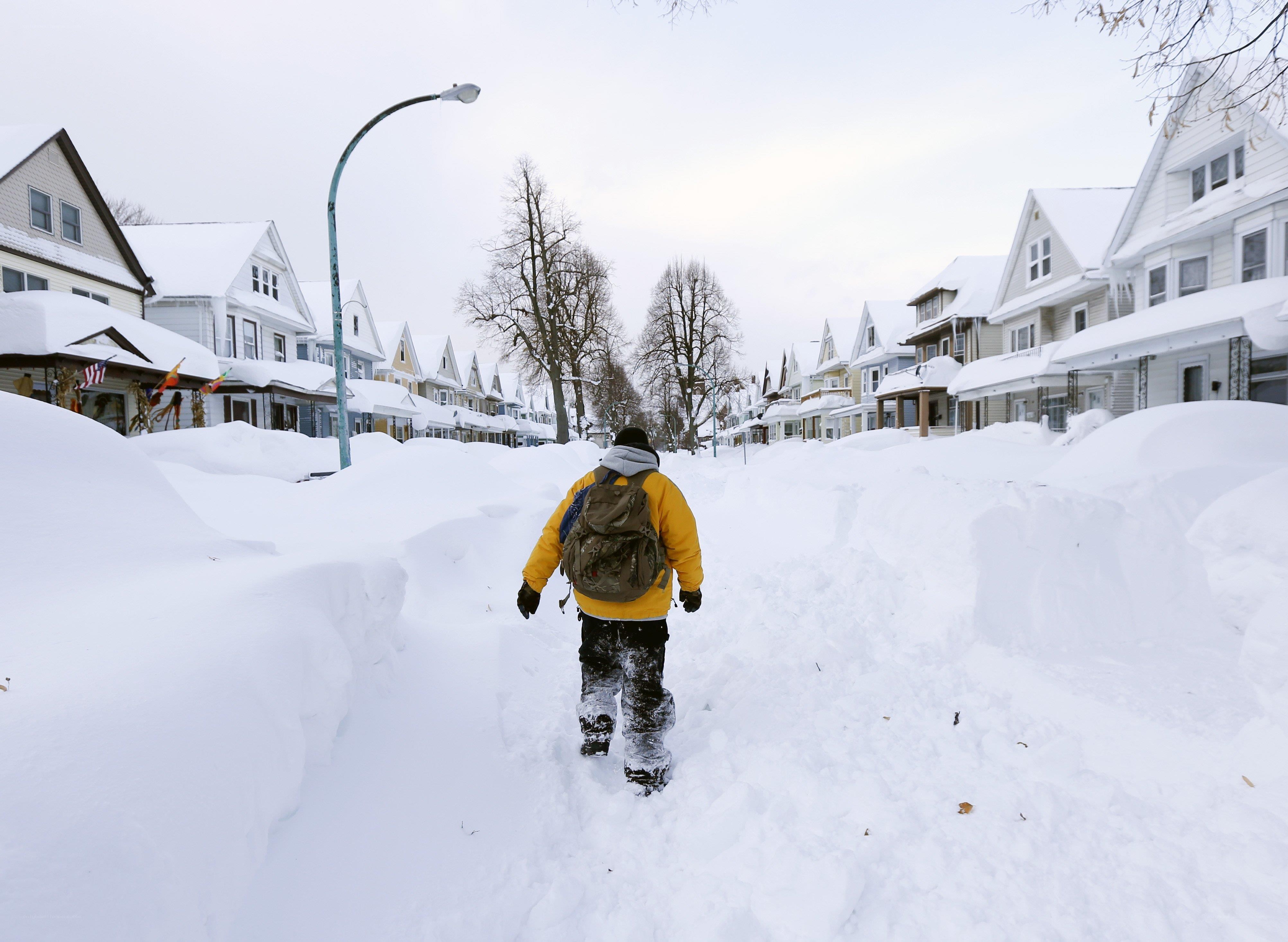 Person walking through snow-covered street