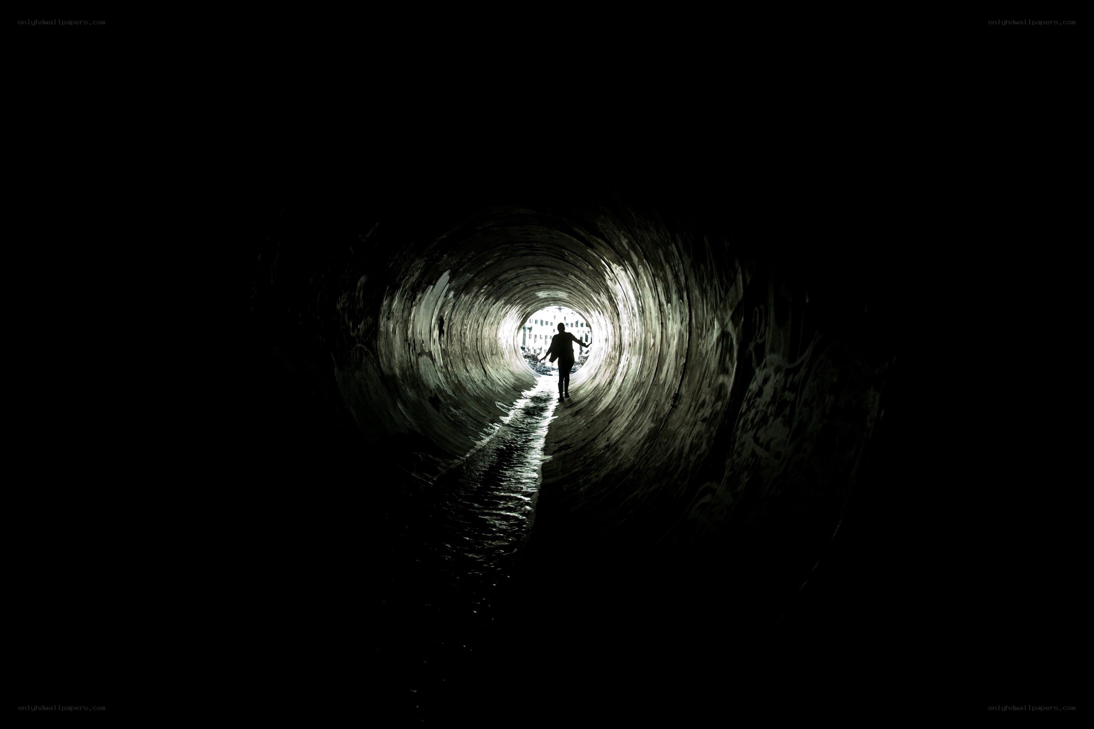 person walking through tunnel