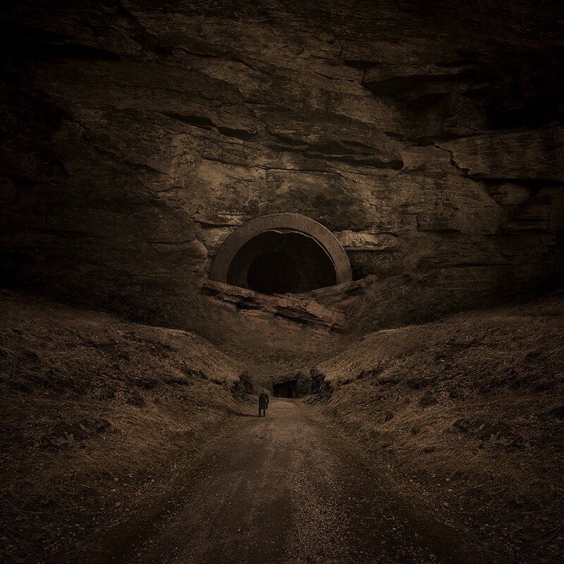Person walking toward cave entrance