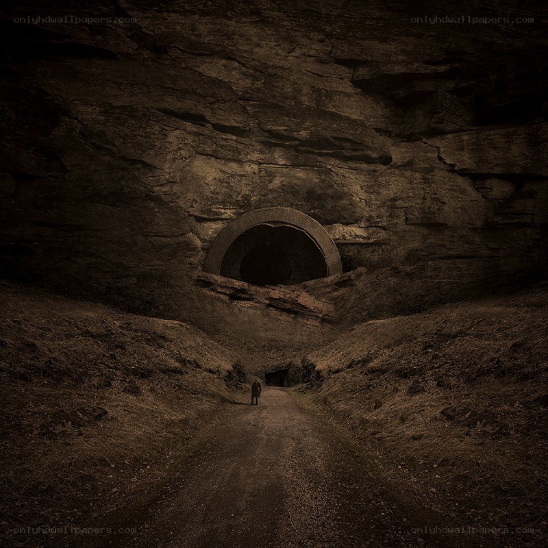 Person walking toward cave entrance