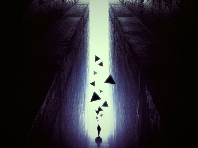 person walking toward light