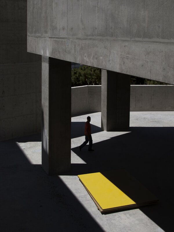 Person Walking under Concrete Structure