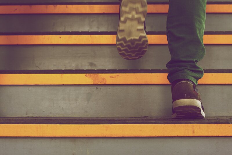 Person Walking Up Stairs — Orange