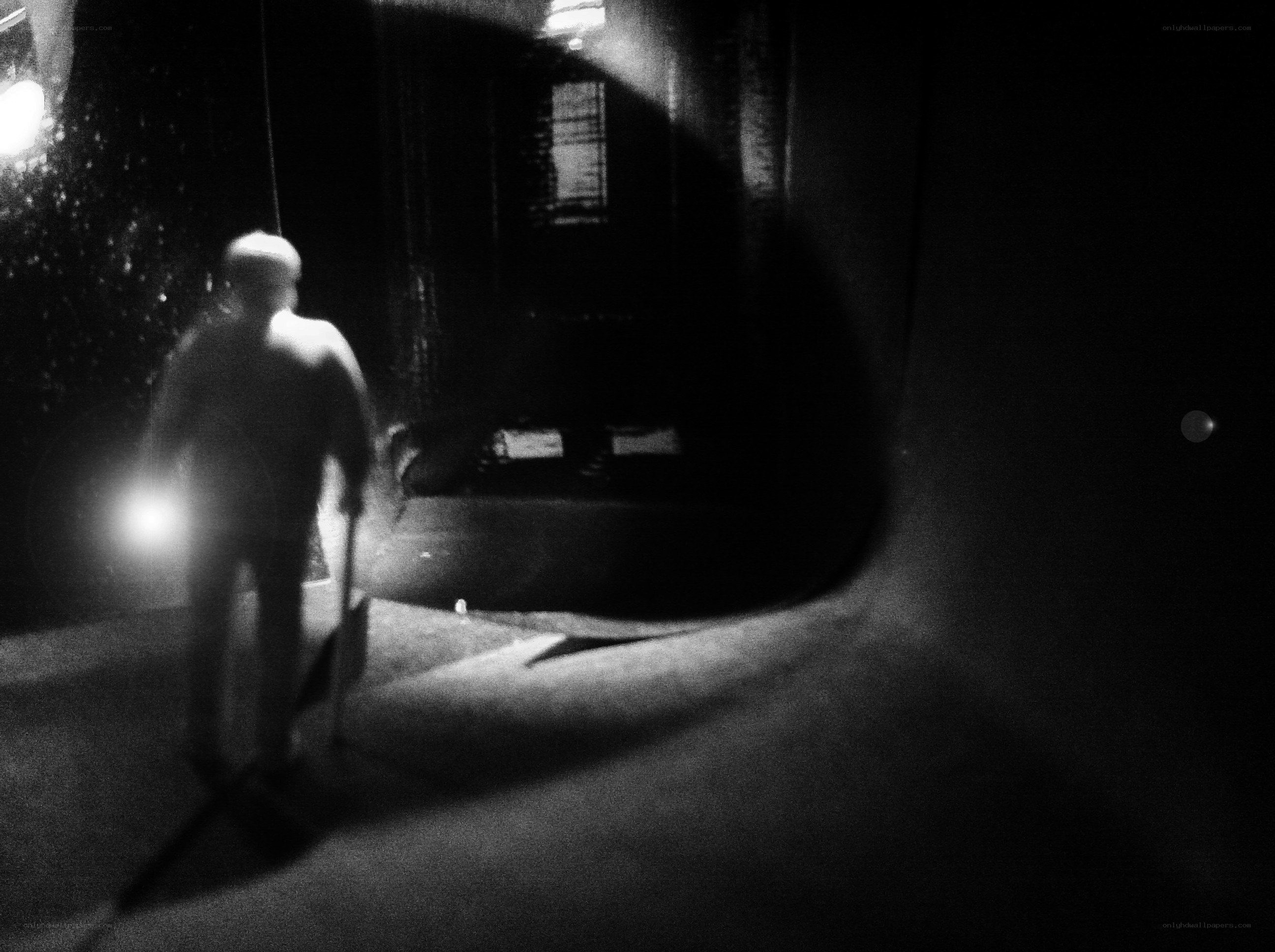 person walking with cane at night