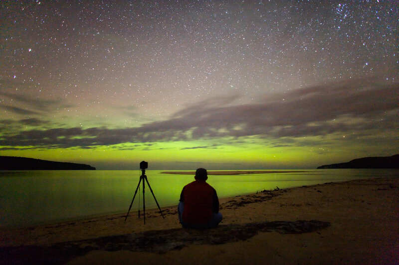 Person watching aurora at night