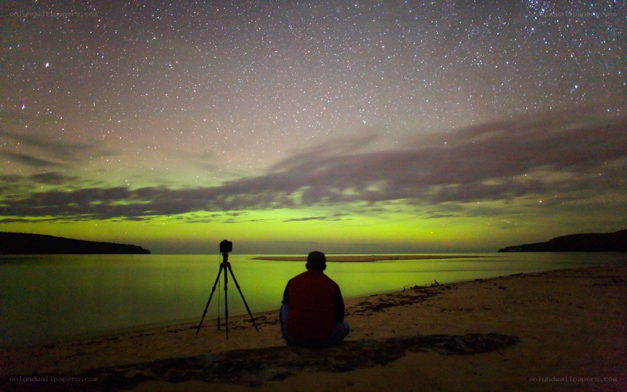 Person watching aurora at night