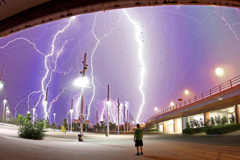 Person watching lightning storm