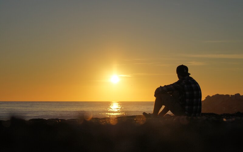 Person watching sunset at beach