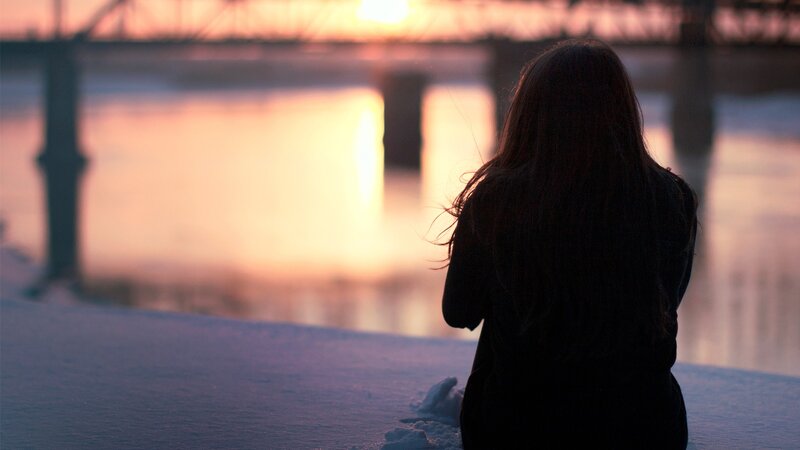 person watching sunset by the water