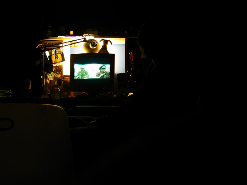 Person watching TV in dark room