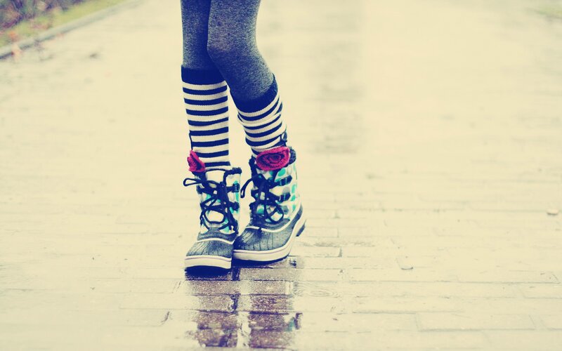 person wearing boots and striped socks