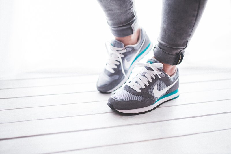person wearing gray sneakers
