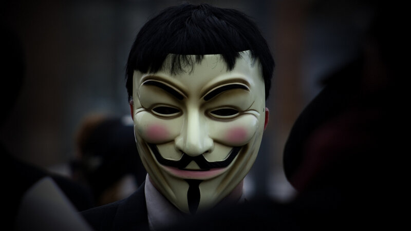 person wearing guy fawkes mask