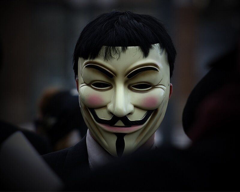 person wearing guy fawkes mask