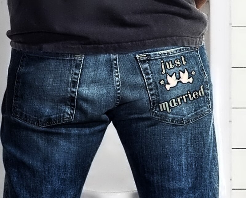 person wearing jeans with 'just married' patch