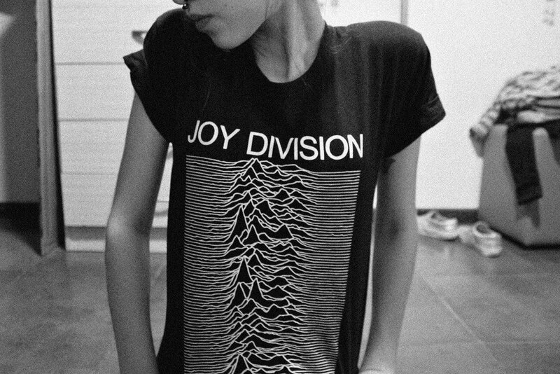 person wearing joy division t-shirt