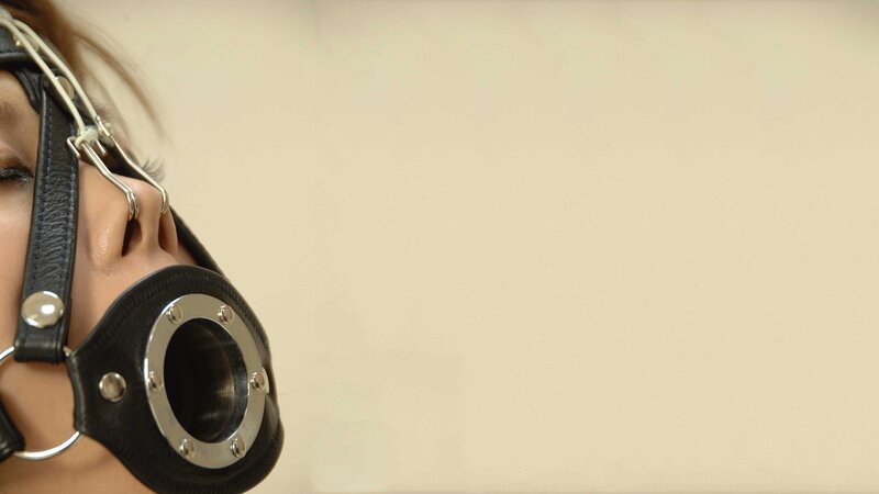 person wearing leather muzzle