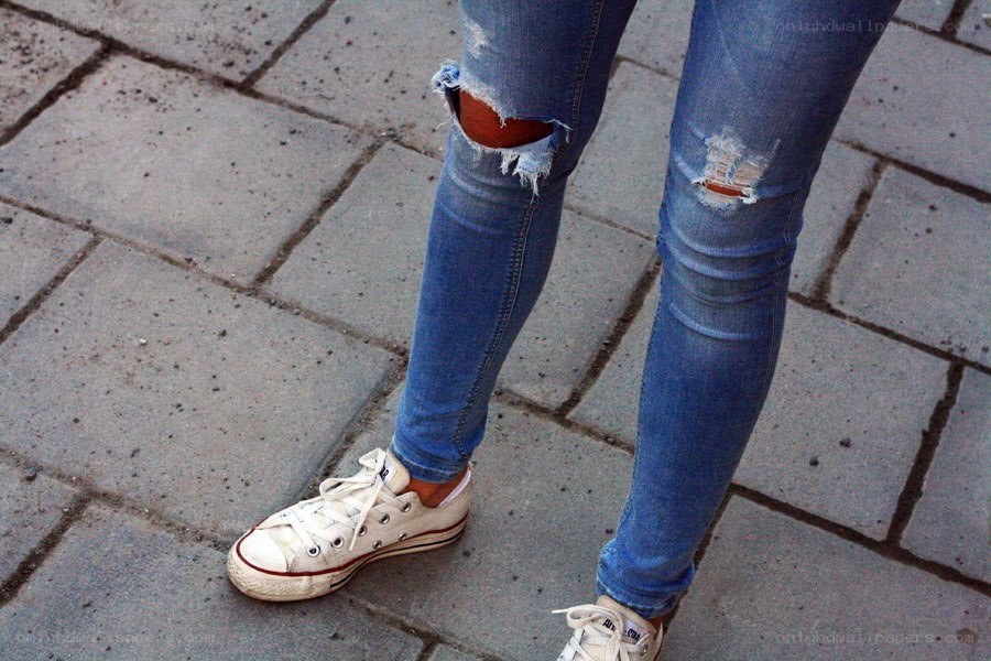 person wearing ripped jeans