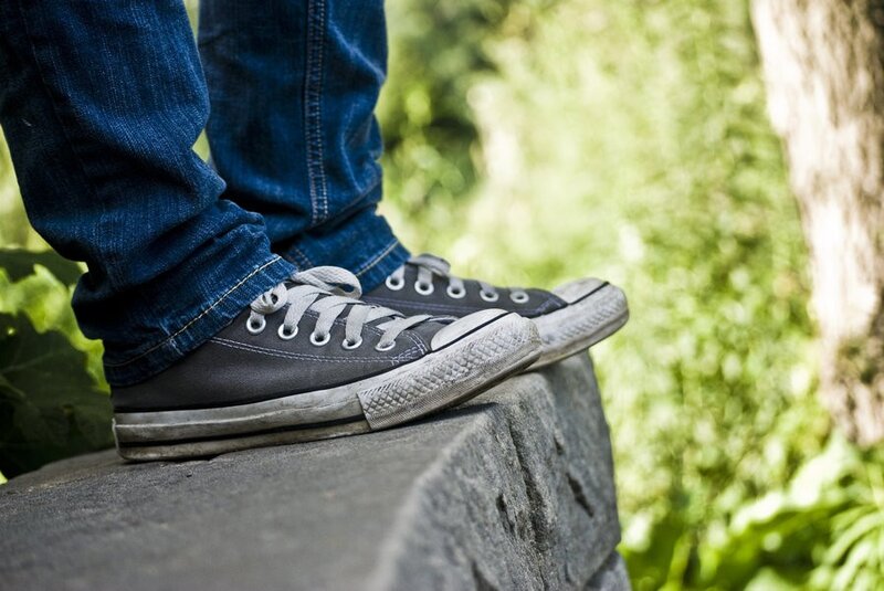 person wearing sneakers on stone