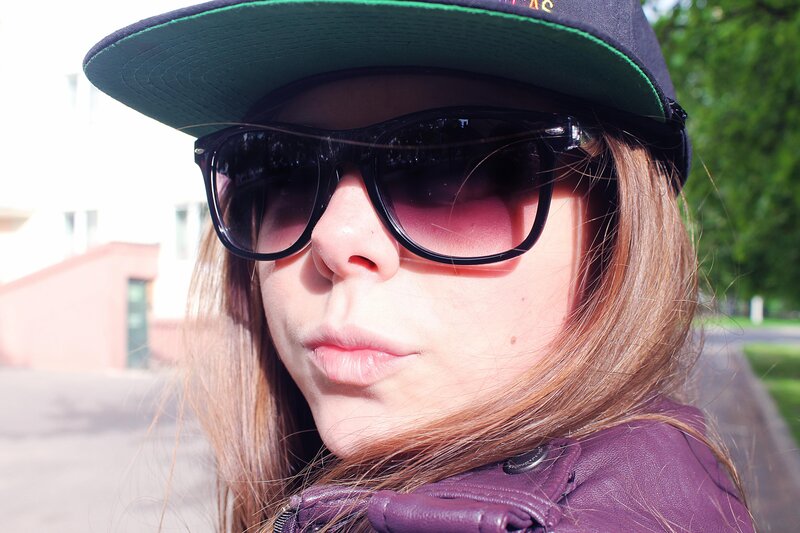 person wearing sunglasses and cap