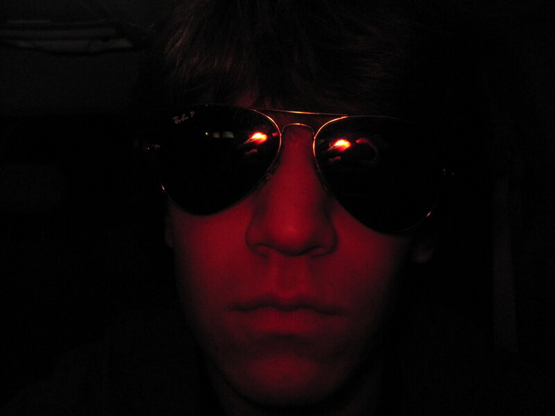 person wearing sunglasses in dark
