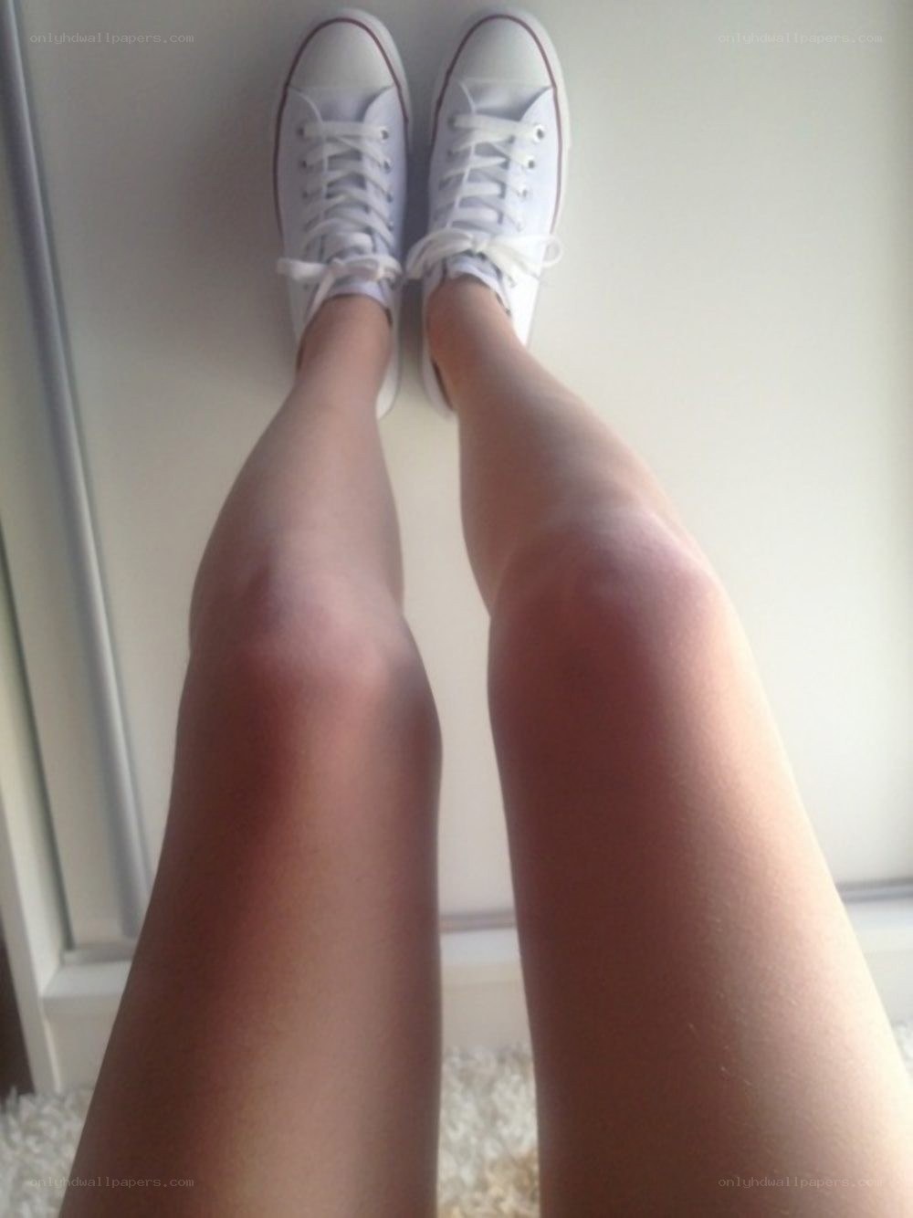 person wearing white sneakers