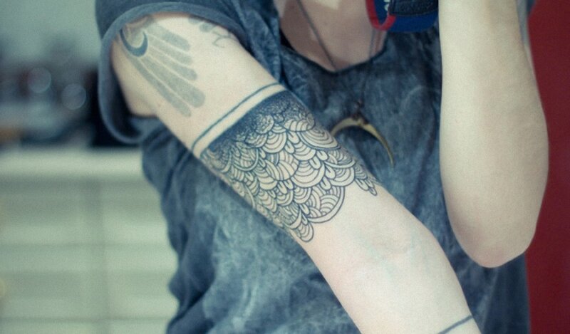 person with arm tattoos