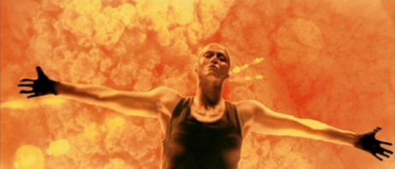 person with arms outstretched in fire