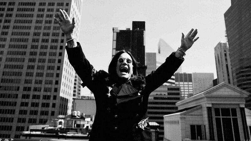 person with arms raised in city