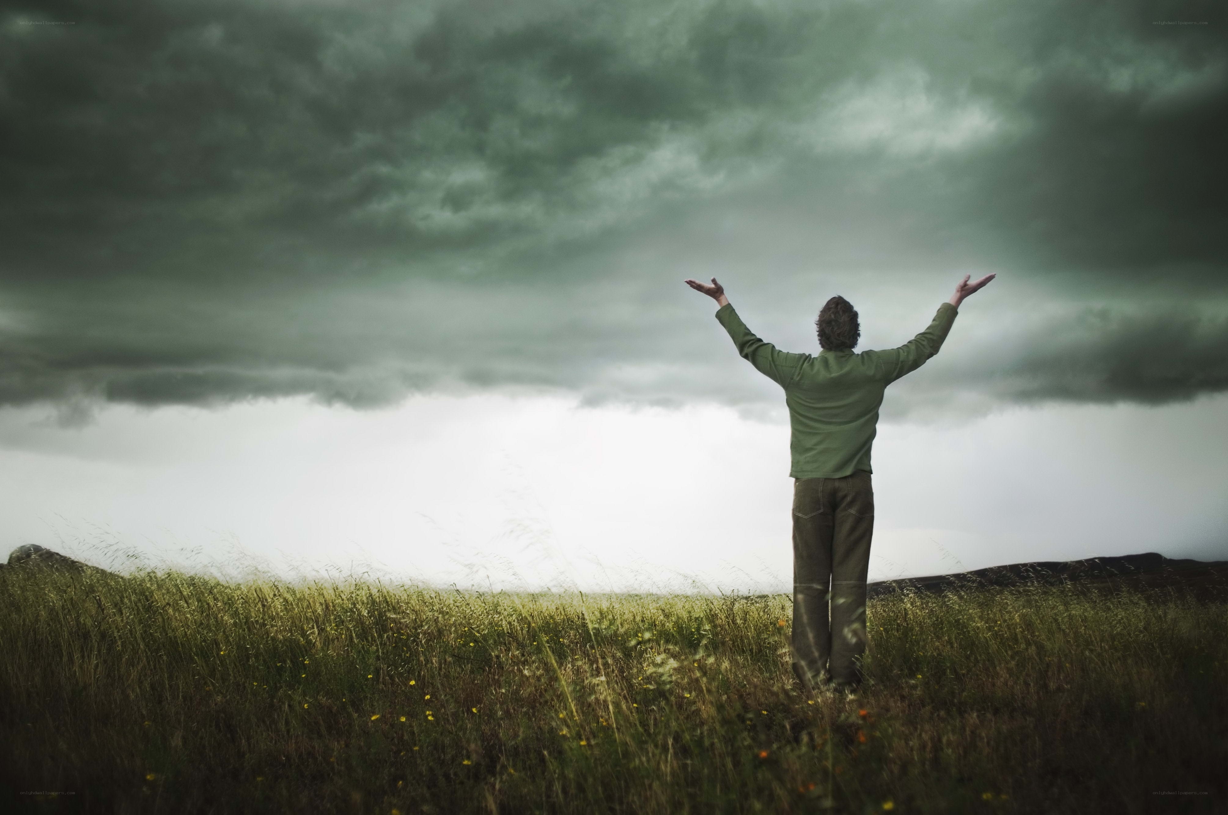 Person with arms raised in field