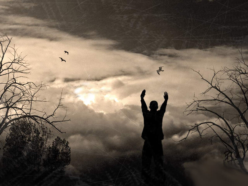 person with arms raised to sky