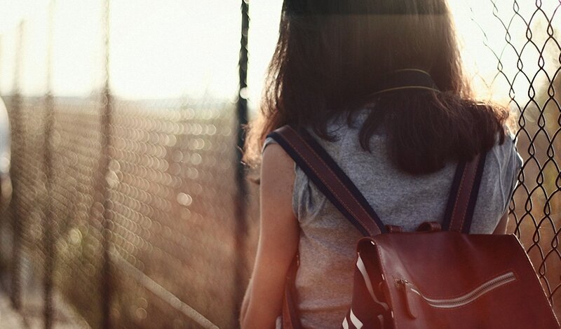 person with backpack at sunset