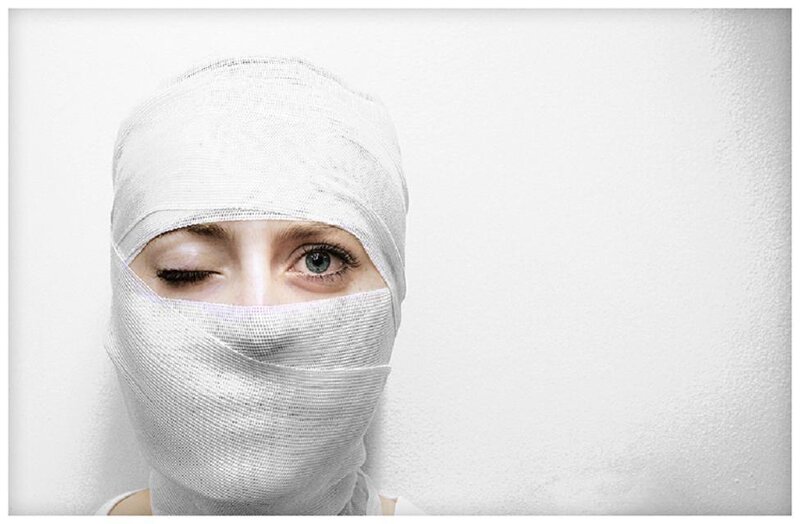 Person with Bandaged Face — White, Dramatic