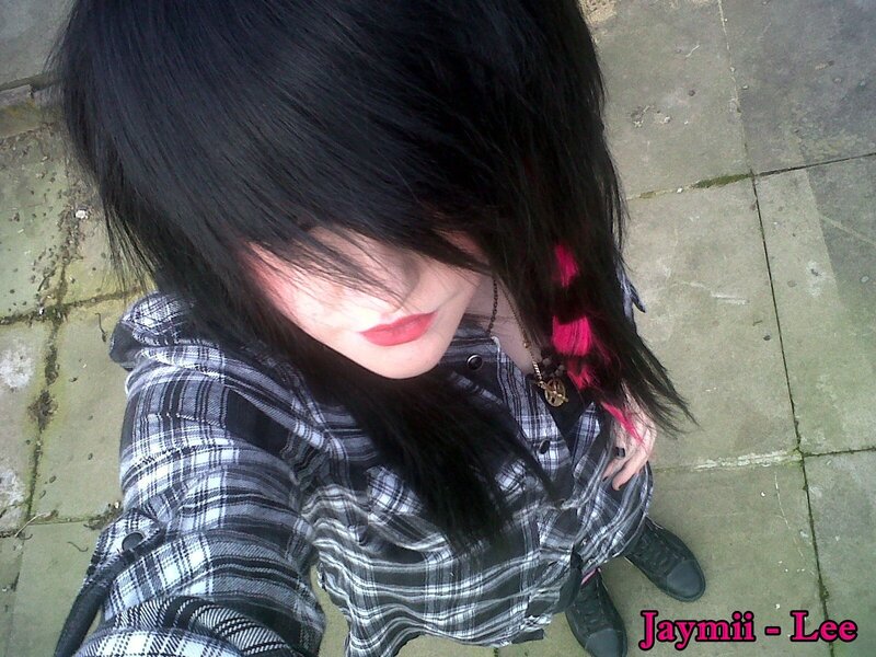 person with black hair and plaid shirt
