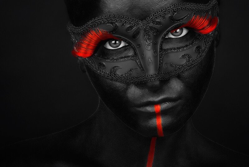 person with black mask and red accents