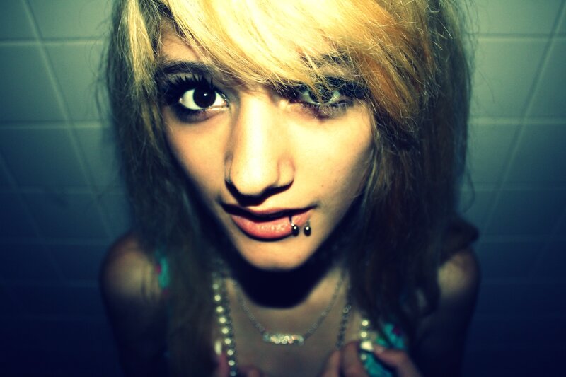person with blonde hair and lip piercing