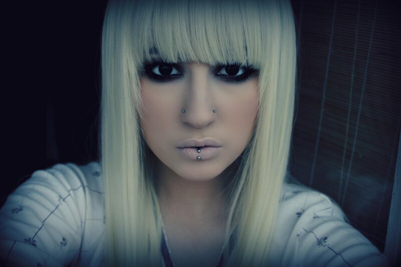 person with blonde hair and piercings